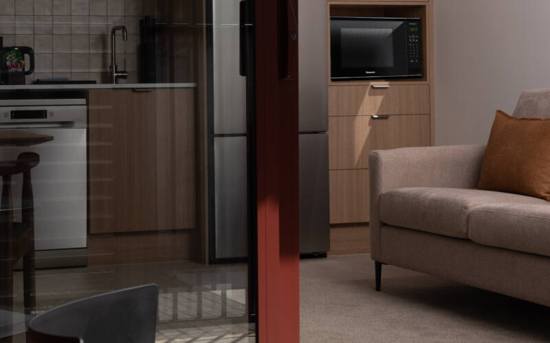 View from the patio of the lounge and kitchen, part of the downstairs living area in the one-bedroom, self-contained apartments of The Kilmore Collection, Christchurch.